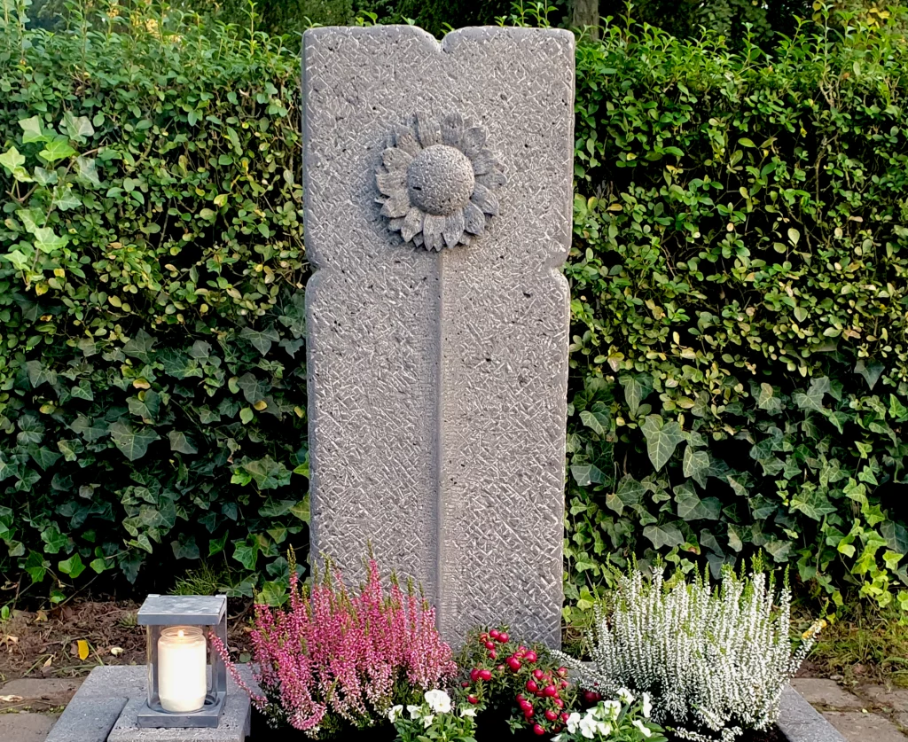 Ein Grabstein mit Sonnenblumen Muster.